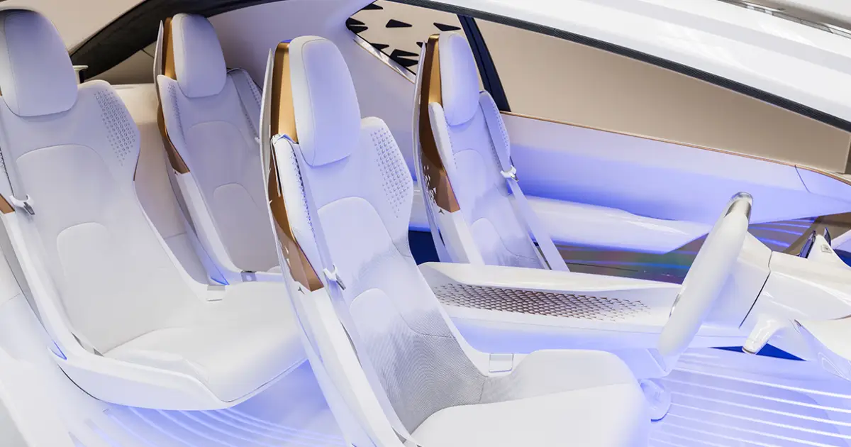 Futuristic concept car interior with sculpted white seats and ambient blue lighting