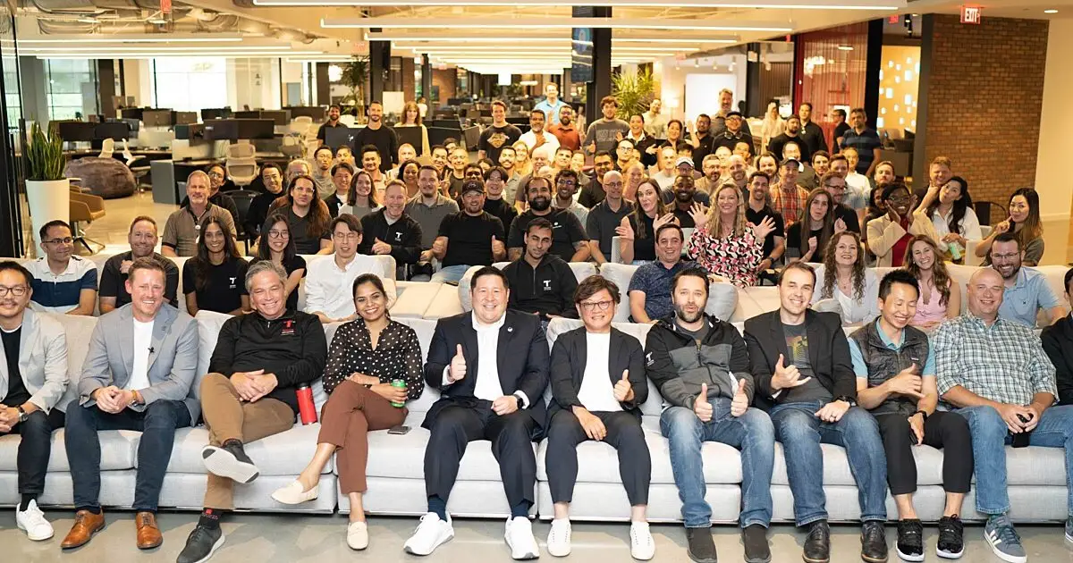 Large group of employees seated together on couches for a company gathering