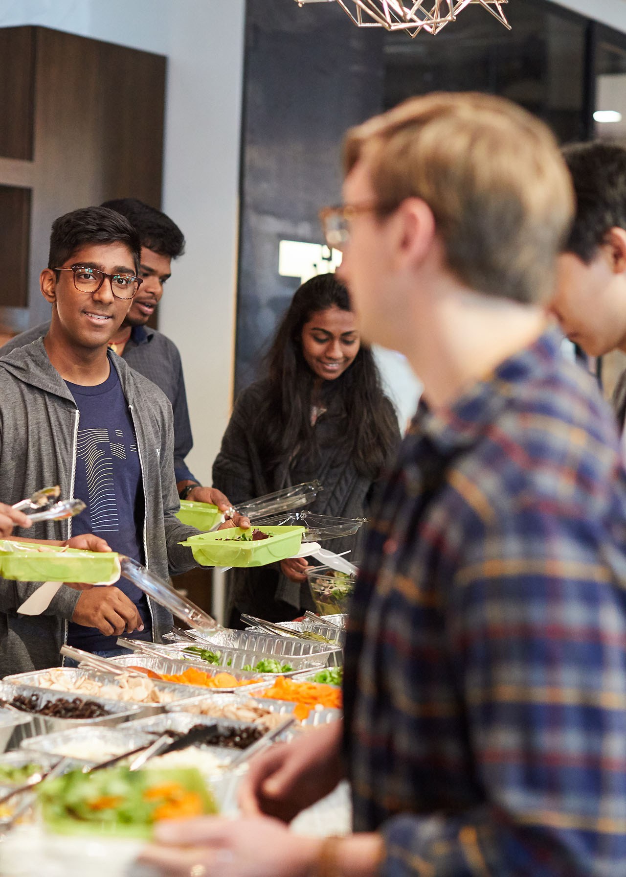 Colleagues sharing food and connecting at a Toyota Connected gathering