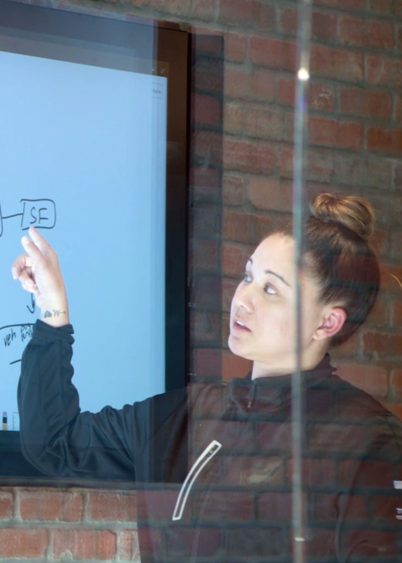 Team member interacting with a wall panel in the office